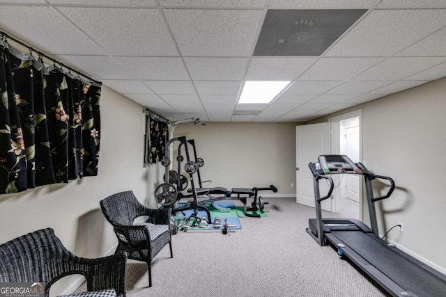 exercise room with carpet and a paneled ceiling