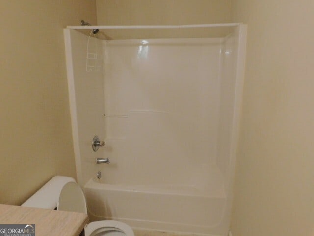 bathroom with toilet and shower / tub combination