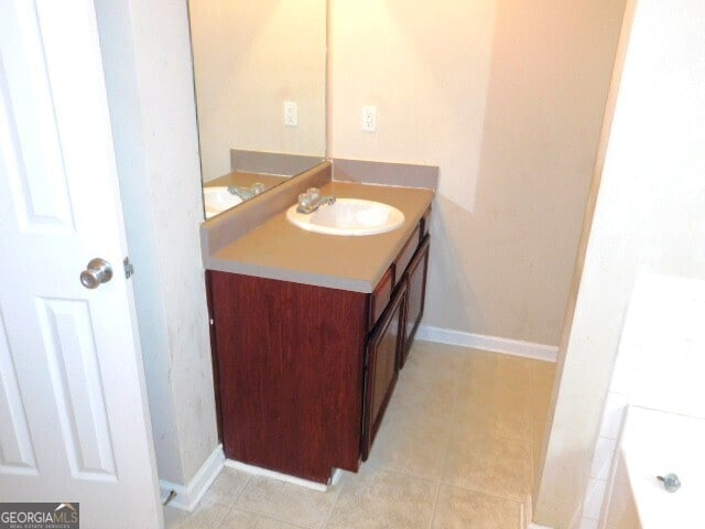 bathroom with tile patterned flooring and vanity