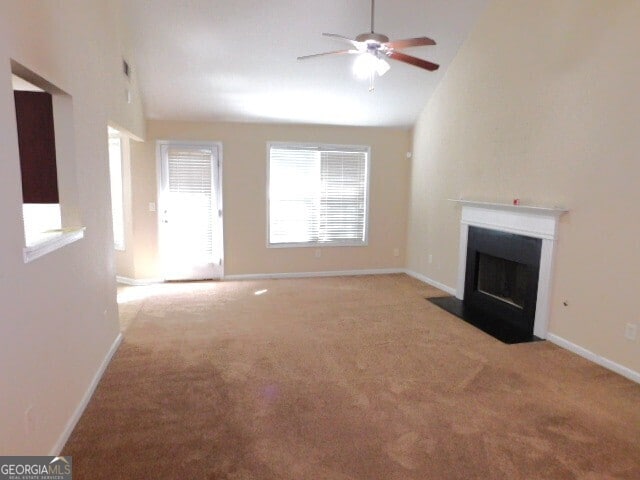 unfurnished living room featuring light colored carpet, high vaulted ceiling, and ceiling fan