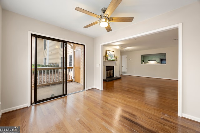 unfurnished living room featuring wood-type flooring and ceiling fan