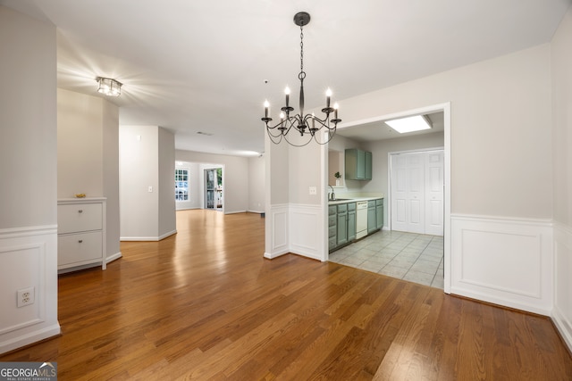 interior space featuring light hardwood / wood-style floors, an inviting chandelier, and sink