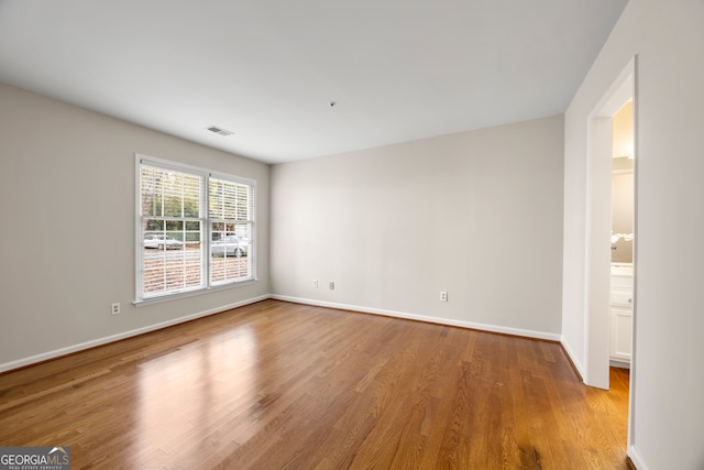 empty room with light hardwood / wood-style flooring