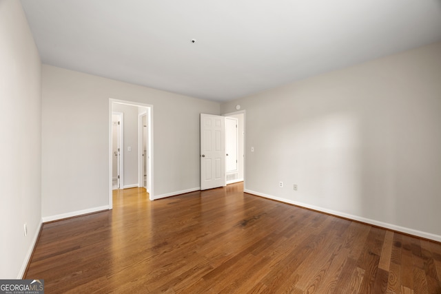 unfurnished room with dark hardwood / wood-style floors