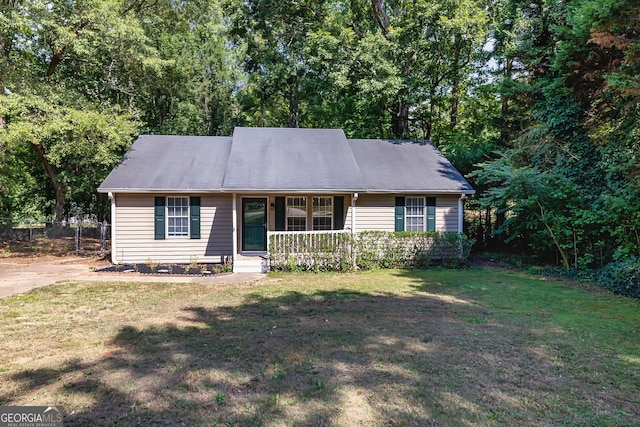 ranch-style home with covered porch and a front lawn