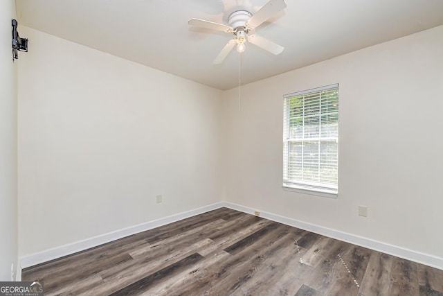 spare room with ceiling fan and dark hardwood / wood-style flooring