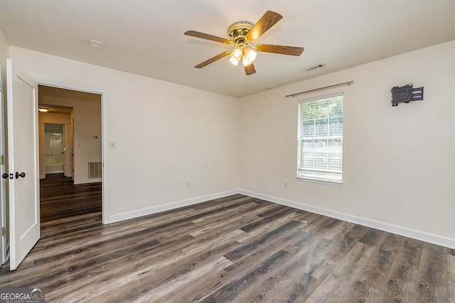 spare room with ceiling fan and dark hardwood / wood-style flooring