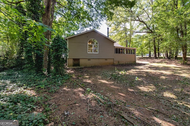 view of side of home featuring a sunroom