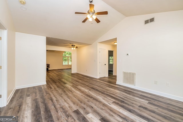 unfurnished living room featuring dark hardwood / wood-style flooring, vaulted ceiling, and ceiling fan