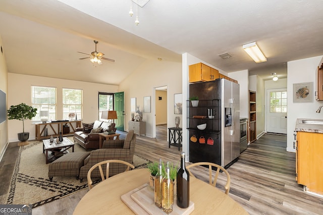 dining area with vaulted ceiling, ceiling fan, sink, and dark hardwood / wood-style floors