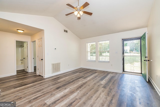 empty room with vaulted ceiling, ceiling fan, and dark wood-type flooring