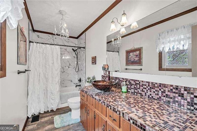 full bathroom with tasteful backsplash, ornamental molding, wood-type flooring, a notable chandelier, and toilet