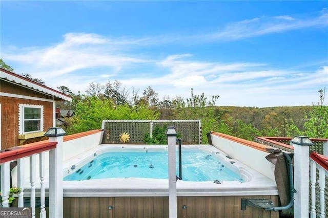 view of swimming pool featuring a hot tub