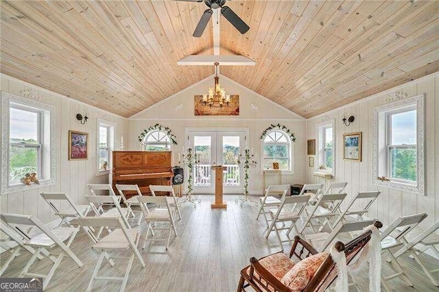 dining area featuring lofted ceiling, a wealth of natural light, light hardwood / wood-style flooring, and french doors