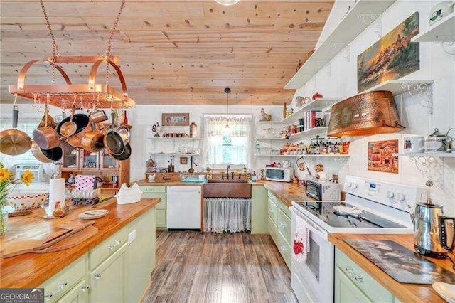 kitchen with white appliances, butcher block countertops, and green cabinets