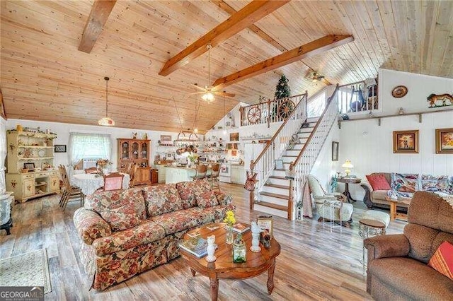 living room with beamed ceiling, hardwood / wood-style flooring, a healthy amount of sunlight, and wood ceiling