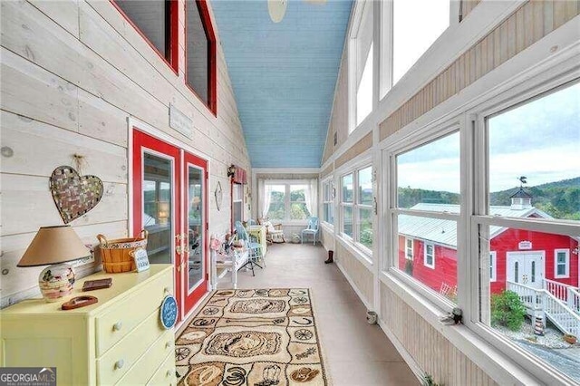 sunroom with french doors, plenty of natural light, and lofted ceiling