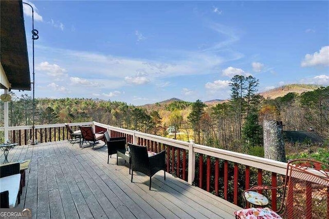 wooden deck with a mountain view