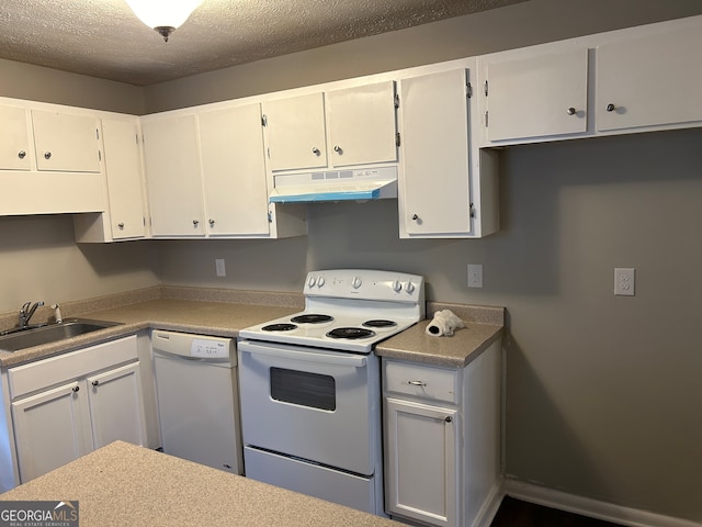 kitchen with white cabinets, white appliances, sink, and a textured ceiling