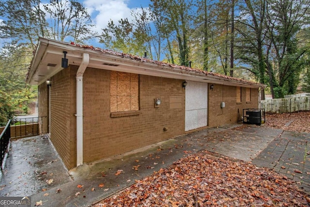 view of property exterior featuring a patio area and central AC