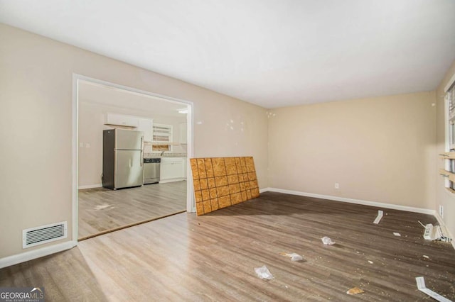 unfurnished living room with hardwood / wood-style floors