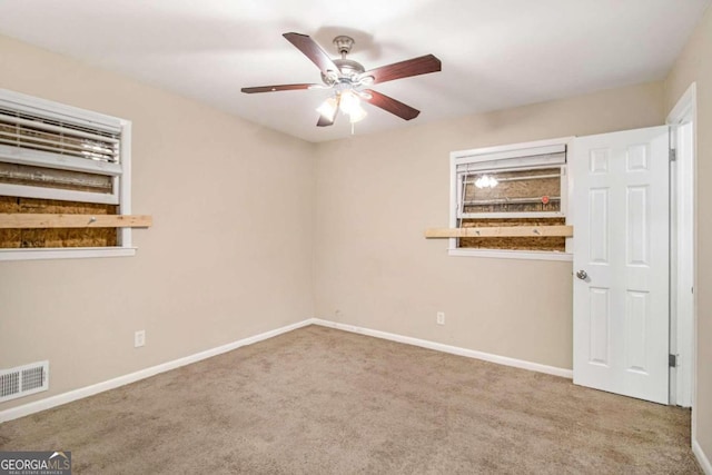 empty room with carpet and ceiling fan