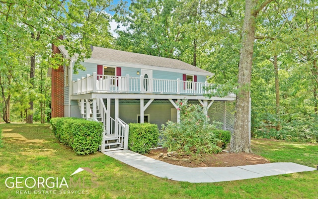 view of front of house with a deck and a front yard