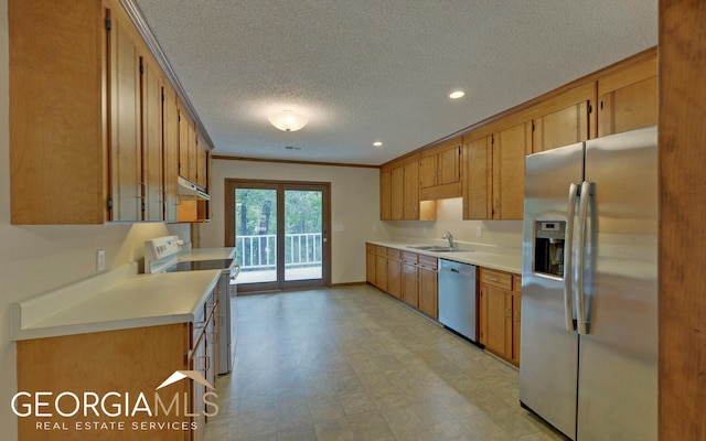 kitchen featuring a textured ceiling, sink, ornamental molding, and stainless steel appliances