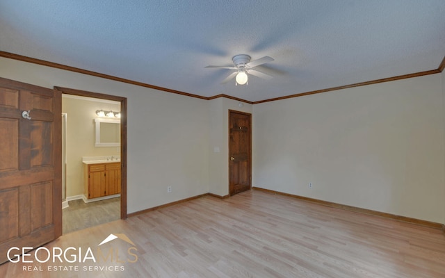 unfurnished bedroom with ensuite bath, ceiling fan, a textured ceiling, and light wood-type flooring