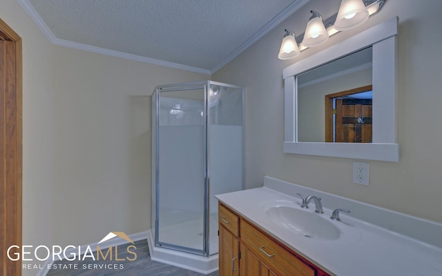 bathroom featuring vanity, crown molding, a textured ceiling, and walk in shower