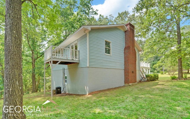 view of home's exterior with cooling unit, a deck, and a yard