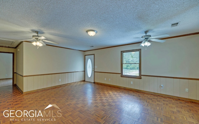 unfurnished room with ceiling fan, crown molding, and a textured ceiling