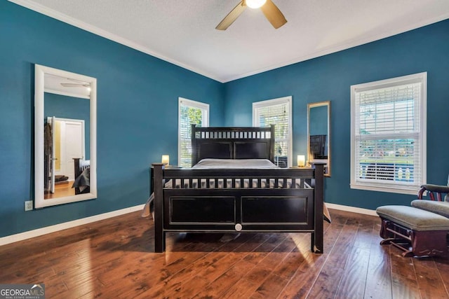 bedroom featuring a textured ceiling, dark hardwood / wood-style floors, multiple windows, and ceiling fan