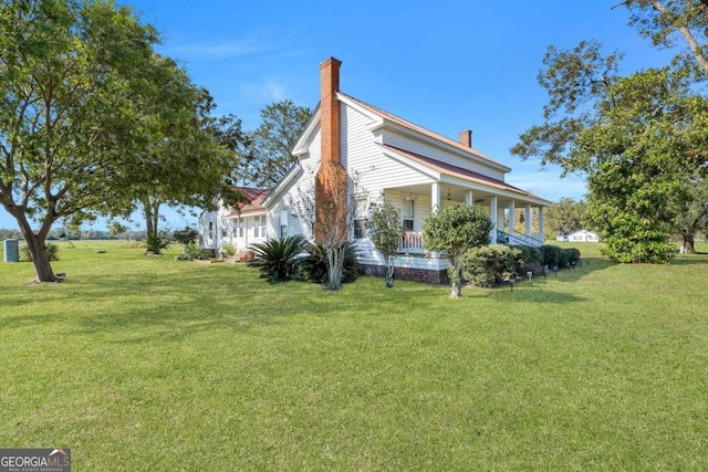 view of property exterior featuring a porch and a yard