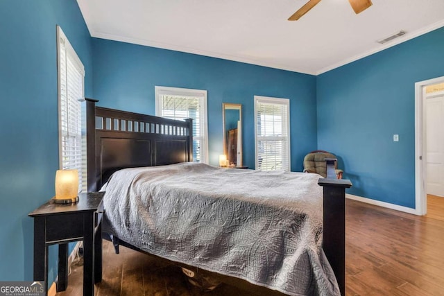 bedroom featuring ceiling fan, crown molding, and wood-type flooring