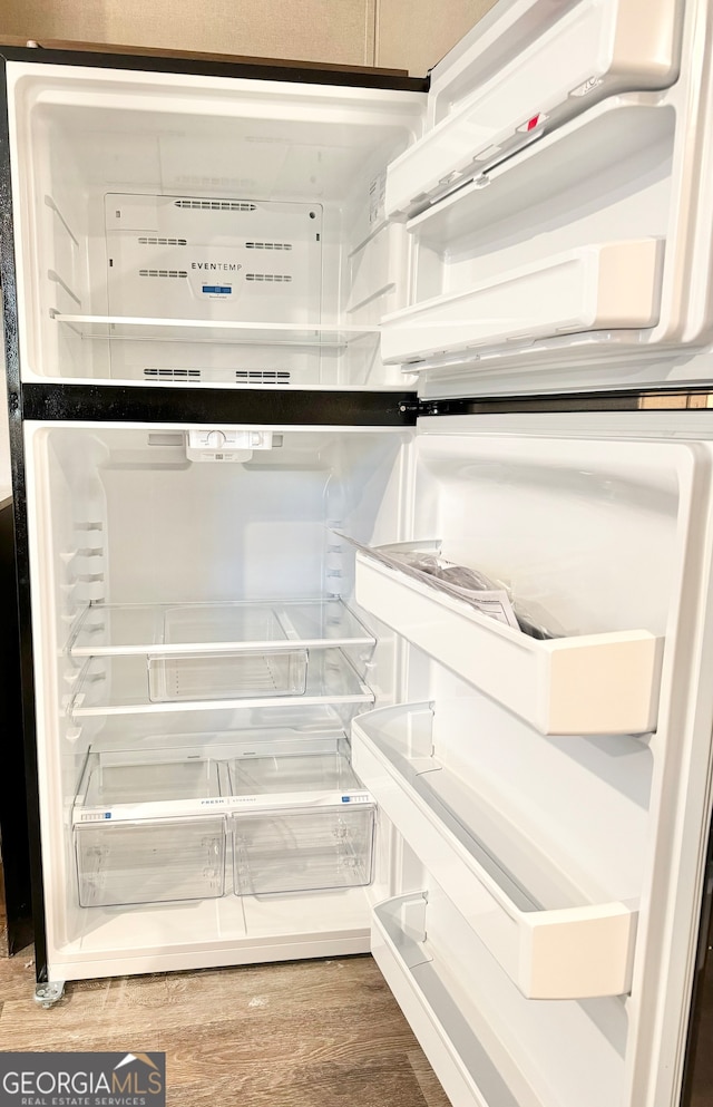 interior details with hardwood / wood-style floors and white refrigerator