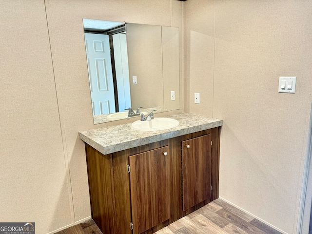 bathroom with vanity and hardwood / wood-style flooring