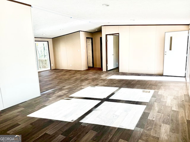 spare room featuring crown molding, a textured ceiling, and hardwood / wood-style flooring