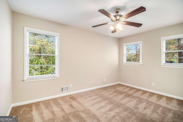 unfurnished room with carpet and ceiling fan