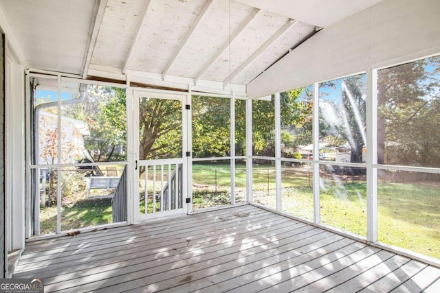 unfurnished sunroom featuring plenty of natural light and lofted ceiling