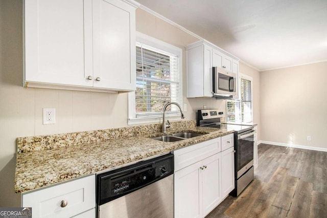 kitchen with sink, ornamental molding, appliances with stainless steel finishes, dark hardwood / wood-style flooring, and white cabinetry