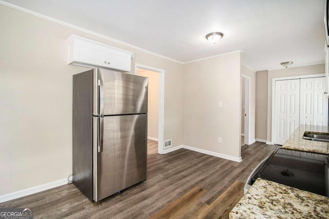 kitchen featuring stainless steel fridge, dark hardwood / wood-style flooring, white cabinetry, and light stone counters