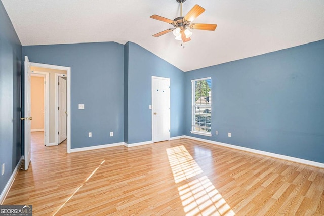 unfurnished bedroom featuring vaulted ceiling, light hardwood / wood-style flooring, and ceiling fan