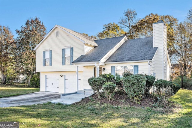 view of front of house featuring a garage and a front lawn