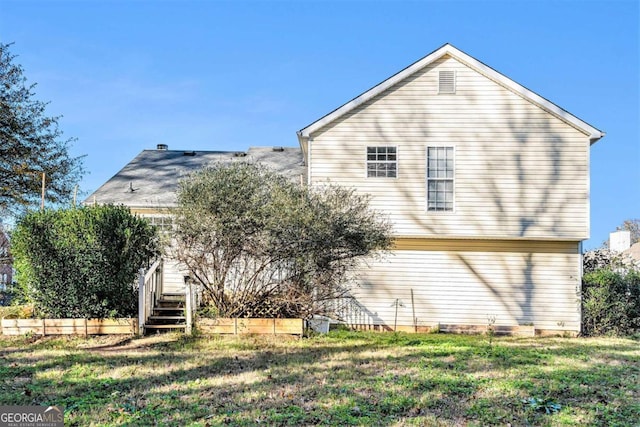 rear view of house with a lawn