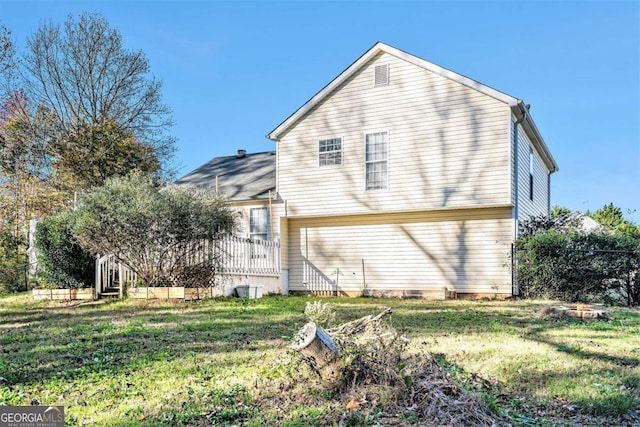 rear view of property with a yard