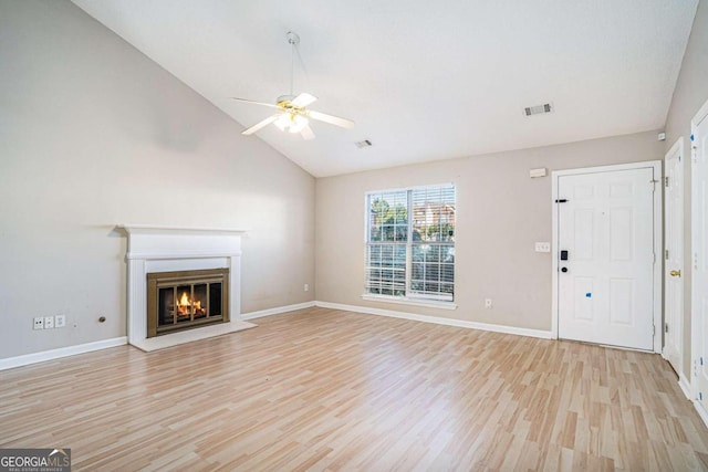 unfurnished living room with ceiling fan, high vaulted ceiling, and light hardwood / wood-style floors