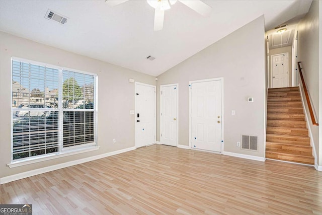 empty room featuring ceiling fan, vaulted ceiling, and light hardwood / wood-style flooring