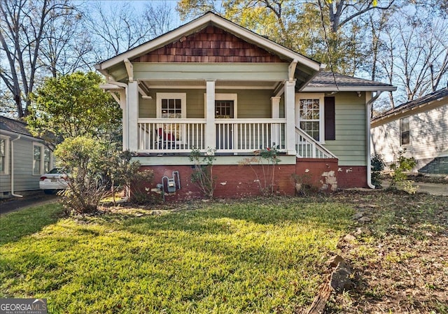 bungalow-style house with covered porch and a front yard