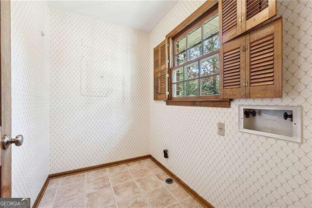 laundry room featuring cabinets, washer hookup, and light tile patterned flooring